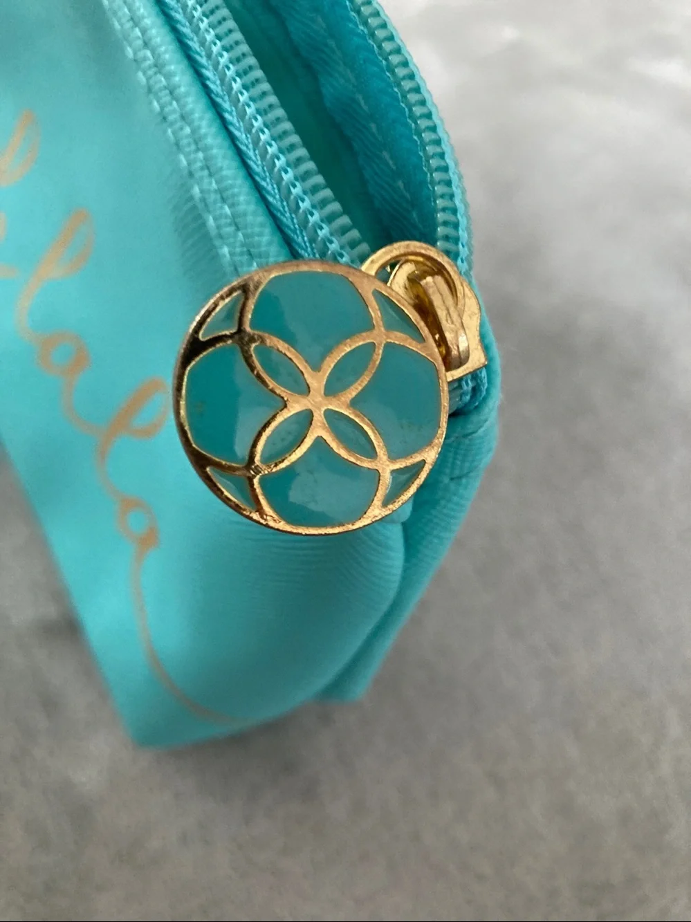Turquoise colored faux leather cosmetic bag
